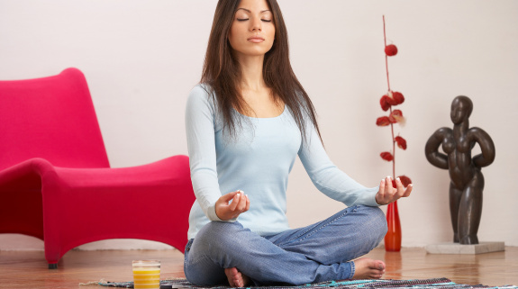 Frau macht daheim Yoga